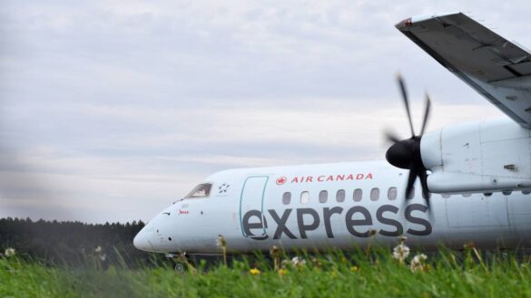 Plane with the words 'Air Canada Express' on the tarmac at Ottawa International Airport.
