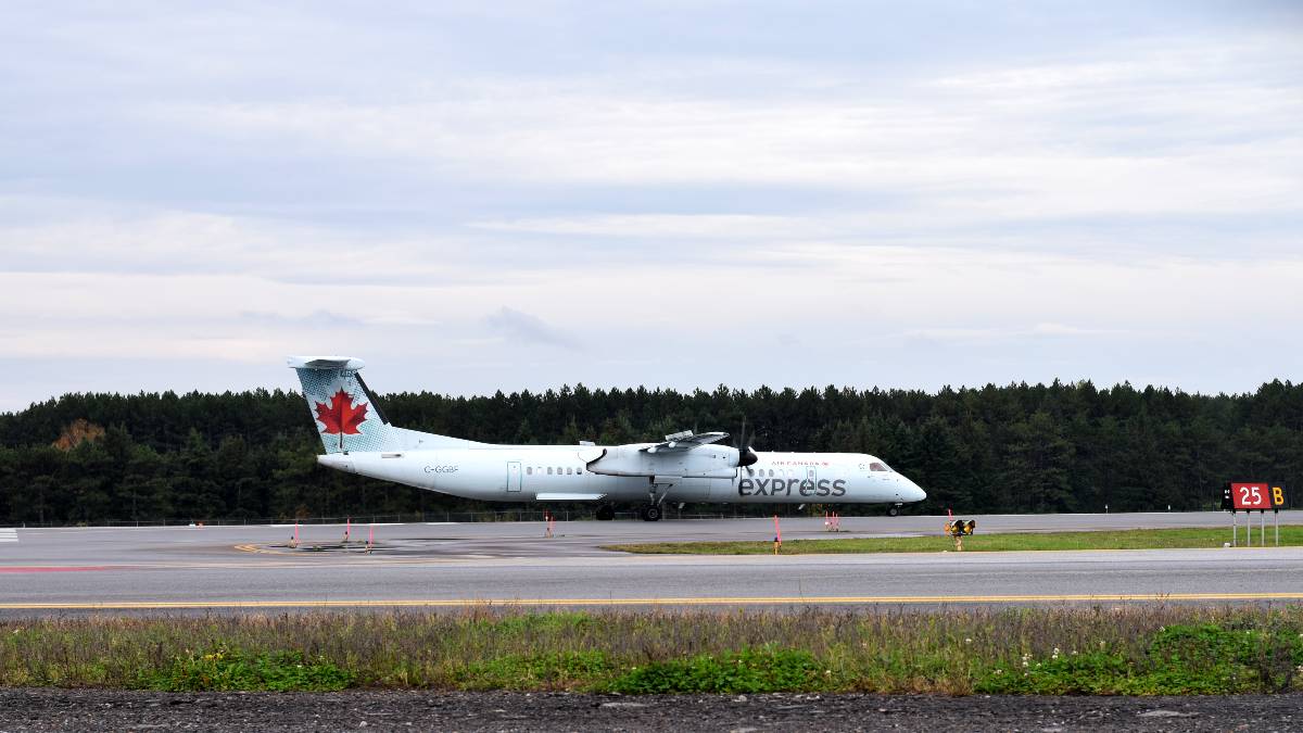 Air Canada Express plane taking off two runways away at Ottawa International Airport.