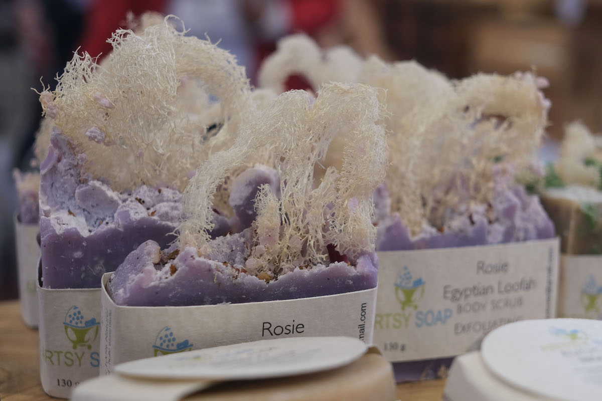 Three purple soaps are in focus, surrounded by many soaps.