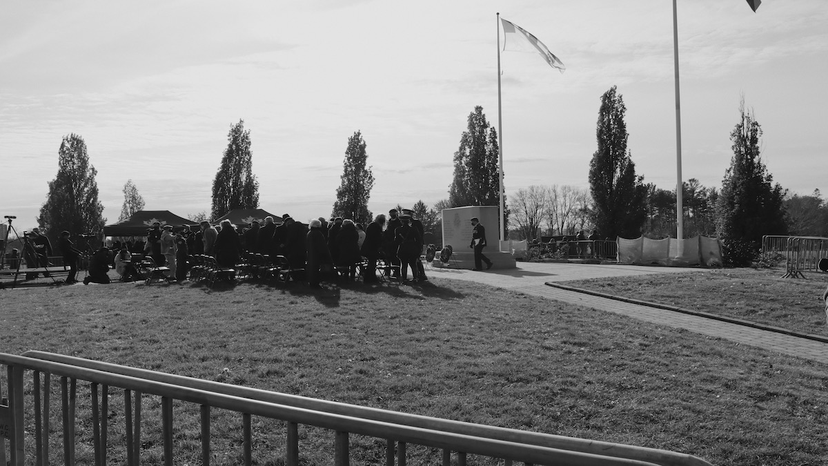 The VIP section of the ceremony, a small crowd, in black and white.