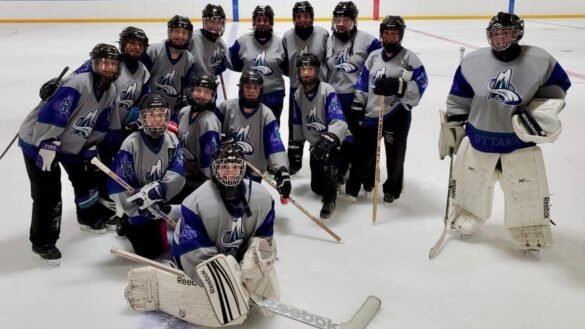 A photo of my ringette team on the ice in full equipment.