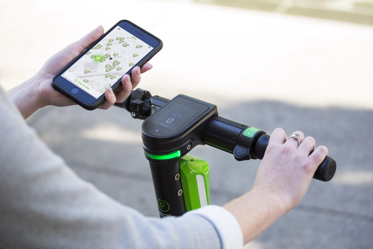 Person using the Lime app to access an e-scooter.