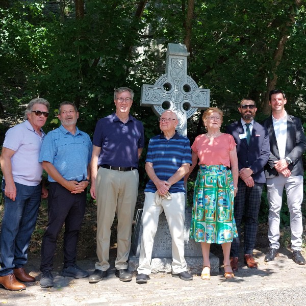 Sean McKenny, Sean Kealey, Jim Watson, Garry Bowes, Clare O'Connell Noon, Grant Vogl and John Boylan stand in front of the Rideau Canal Celtic Cross.