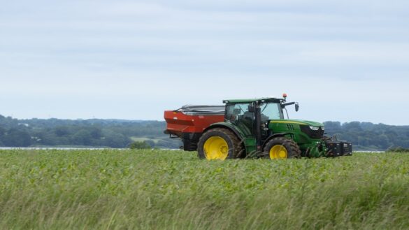 Tractor with fertilizer on a corn field
