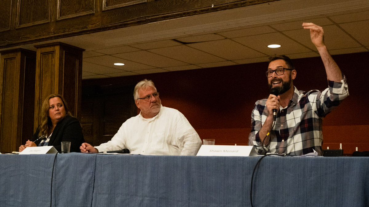 Capital Ward Country. Shawn Menard, Dan Rogers, and Rebecca Bromwich sit at the debate table.