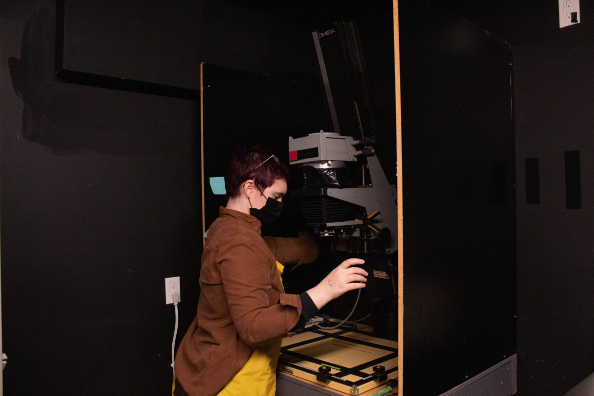 Jamie Polvin prepares to project an image onto the paper print projector