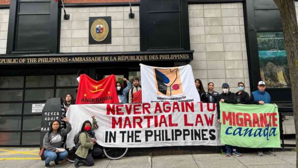 Group of people protesting outside Philippines Embassy with signs