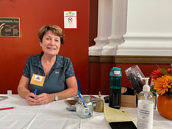 Woman sits at table