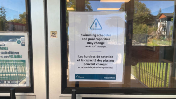 A sign on the door of the Brewer Pool entrance that says "swimming schedules and pool capacities may change due to staff shortages"