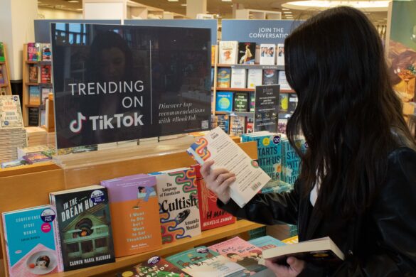 Girl in Chapters Indigo looking at the TikTok book recommendations.