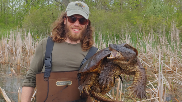 Tyler Ambeau with a snapping turtle
