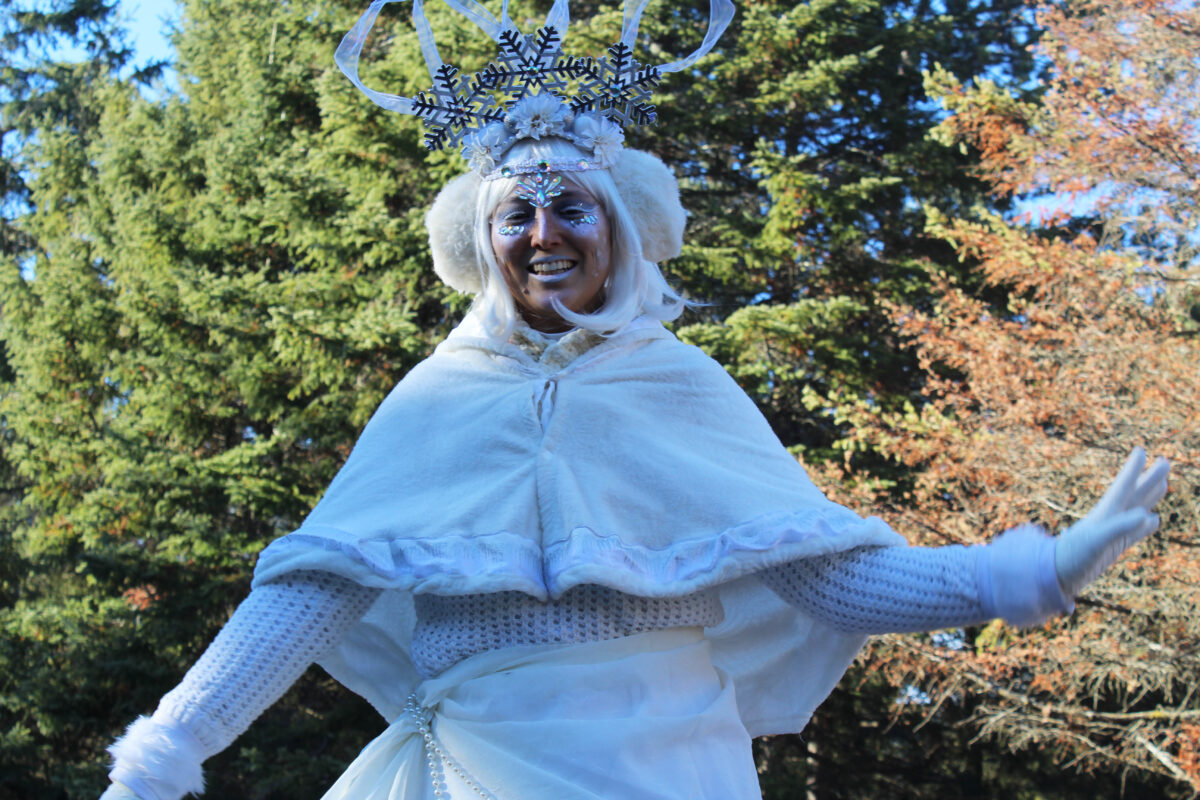 a portrait of a woman dressed in all white as the spirit of winter