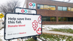 Canadian Blood Services building with sign that says "Help save lives this fall. Donate blood."