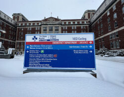 The blue sign outside of the Ottawa Hospital (Civic Campus) on a snowy day.