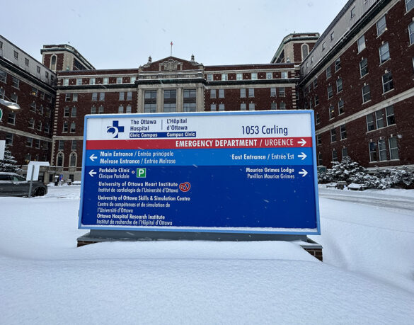The blue sign outside of the Ottawa Hospital (Civic Campus) on a snowy day.