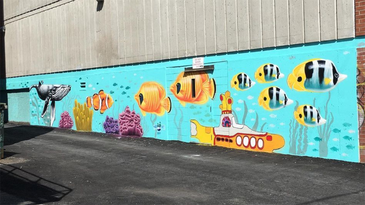 A large mural with fish painted on it, a submarine and a whale.