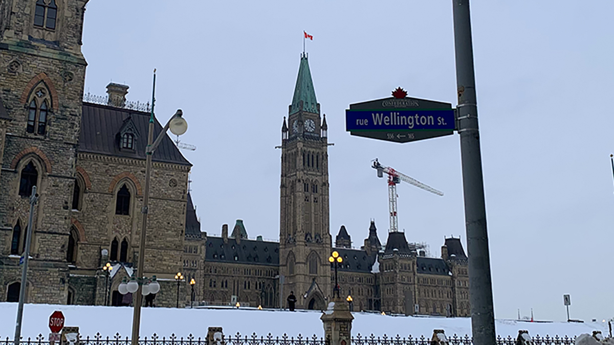 Wellington Street sign, Parliament in background.