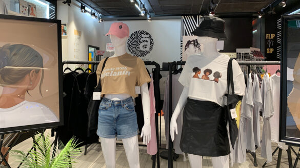 Two mannequins stand inside a clothing store. They are wearing crop tops and shorts designed by Black designers.