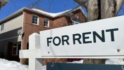 A "for rent" sign stands in front of a property