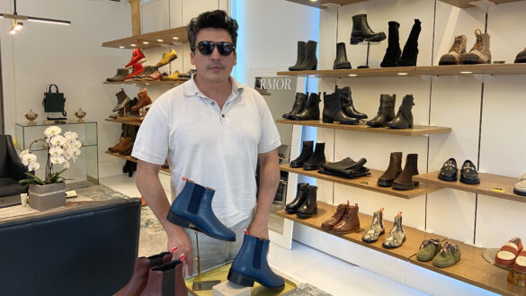A man with sunglasses on, in a shoe boutique.
