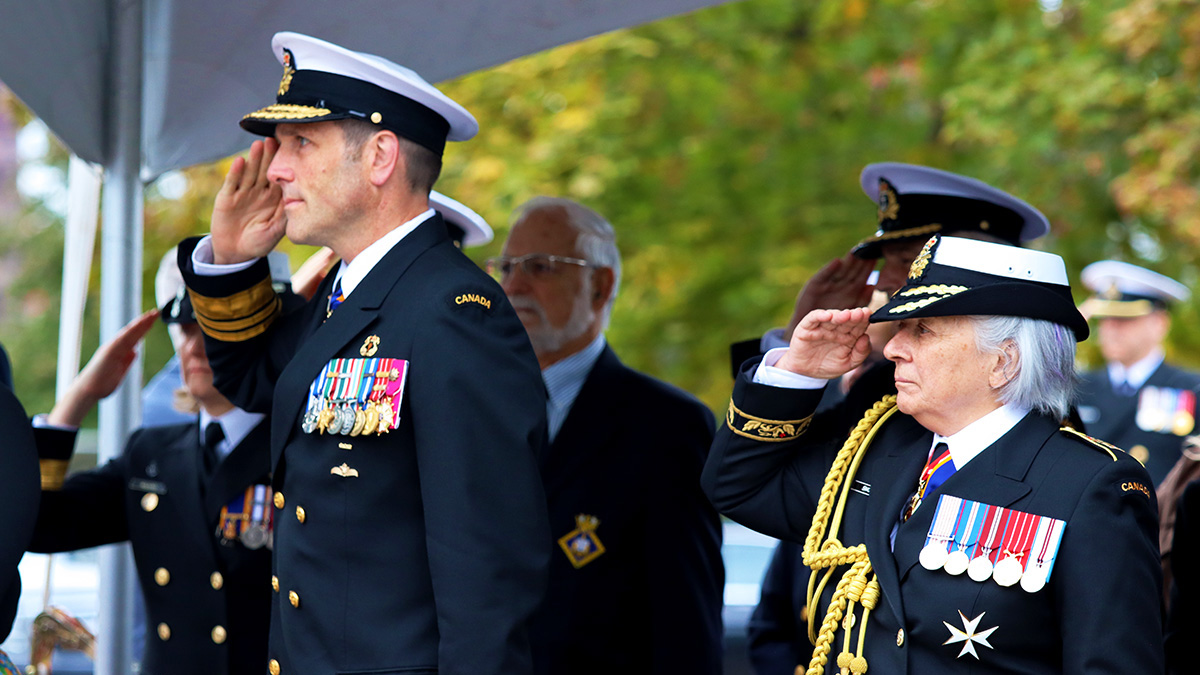 The Commander of the Royal Canadian Navy, Angus Topshee, and Her Excellency Gov. Gen. Mary Simon, saluting the flag during the singing of the Canadian national anthem at the Rededication of the National Naval Reserve Monument at HMCS Carleton in Ottawa on Oct. 2023. [Photo @ Hajar Al Khouzaii]