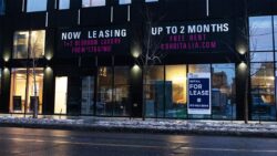 A rent sign on the front of newly constructed apartment in Ottawa.
