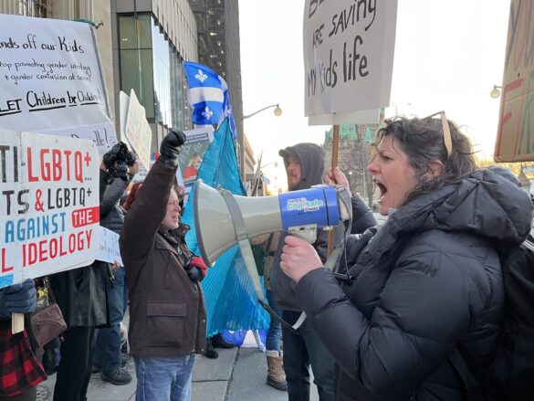 Trans-ally protester yells at counter-protester through a megaphone at Monday's pro-trans rally.