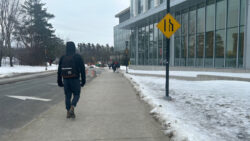 A student walks near the Health Sciences building off of Campus Avenue located at the Carleton University campus in Ottawa Ontario.