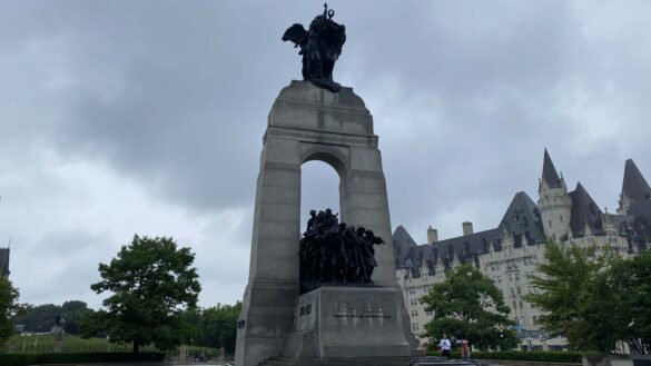 Canadian War Memorial set against a backdrop of grey rain clouds