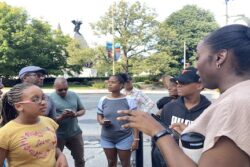 Tour guides discuss Black history at the National War Memorial in downtown Ottawa