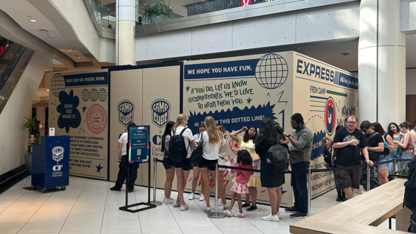 Showing the CAMP Cube and the line of people waiting to enter it.