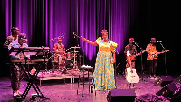 Singer, Empress Nyiringango's band performing on stage.