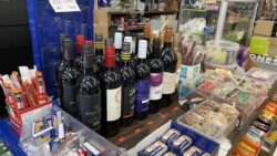 Bottles of wine on a store countertop.