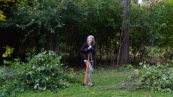 Sharon Boddy stands with a buckthorn extractor at Hampton Park.