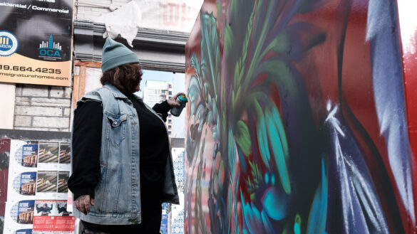 A graffiti artist paints a mural in Ottawa's Byward Market.