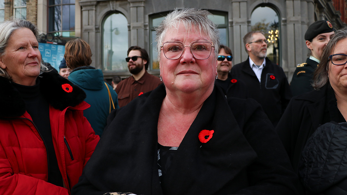 Roberta Beith standing in a crowd of people at the National Remembrance Day Ceremony. 