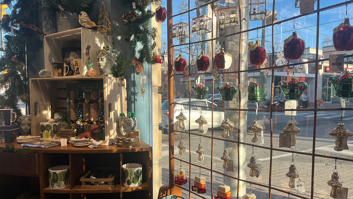 The Papery's window facing Bank Street with various Christmas-themed trinkets. 