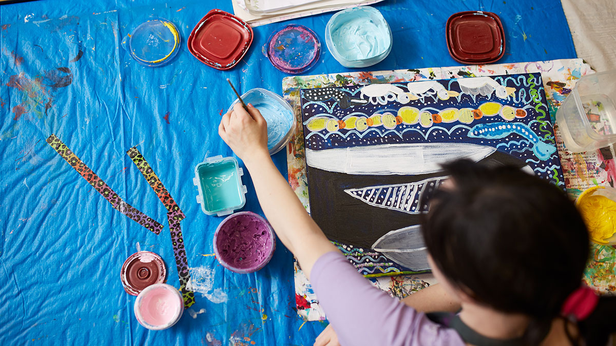 A young painter is pictured in Ottawa's BEING Studio's art space