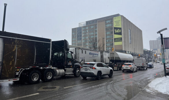 Photo shows traffic congestion on Rideau Street at King Edward Avenue, including several big trucks.