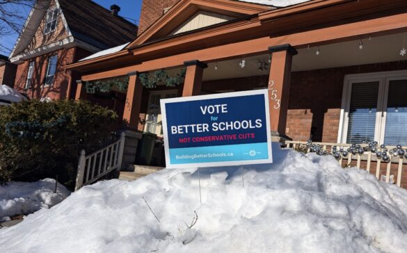 A sign stuck in a snowbank in front of a home in Ottawa reads: "Vote for Better Schools — Not Conservative Cuts"