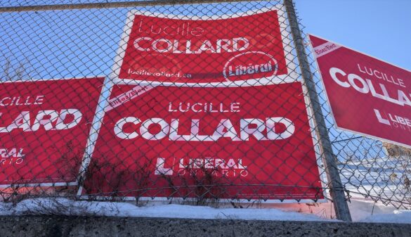 Fence plastered with Liberal candidate's election signs.