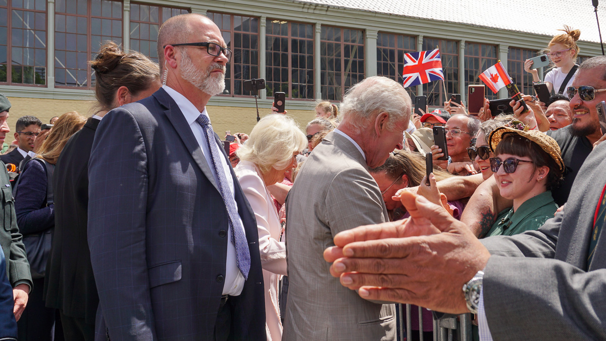 King Charles greets fans behind a barricade in Landsowne Park.