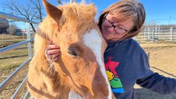 Trina Mather-Simard pets an Ojibwe Spirit Horse at Mādahòkì Farm