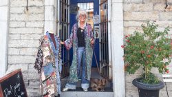 business owner standing in front of her business.