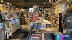 Singing Pebble Books interior featuring warm lighting, trinkets and bookshelves.